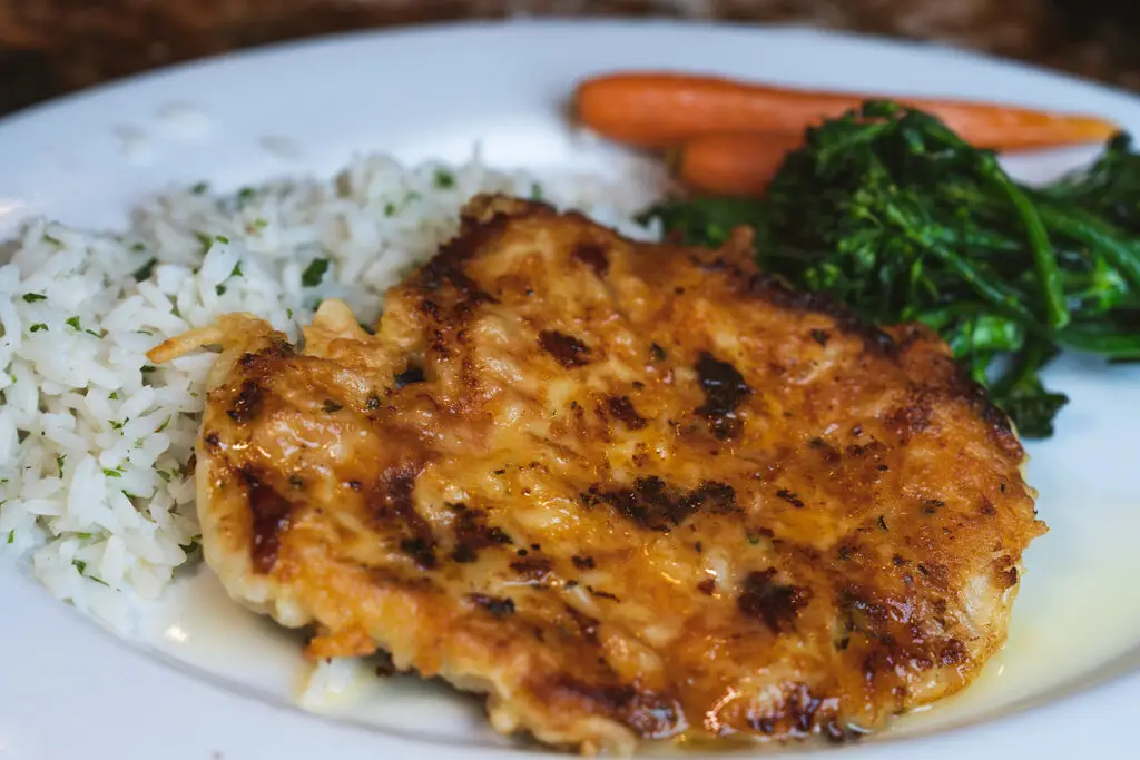 Rice and chicken with a side of carrots and broccolini by the 8th Street at the Ivy