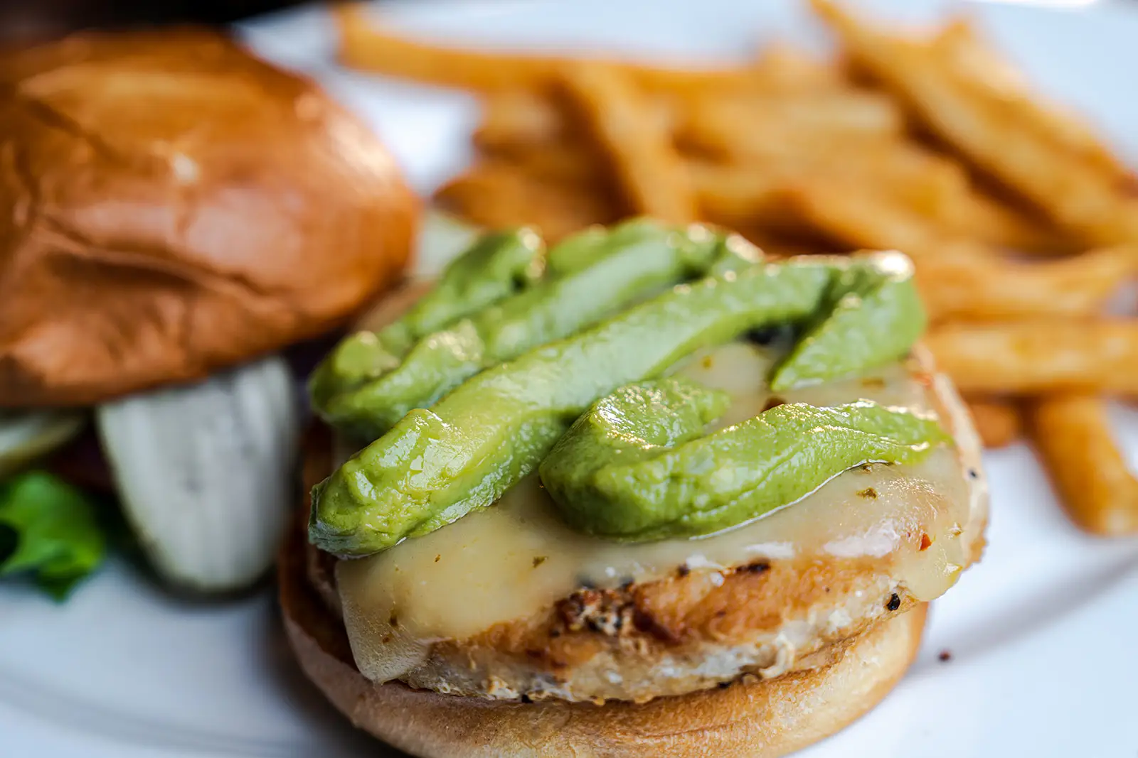 Southwest Turkey Burger with a side of french fries by Grilled salmon served with rice and broccolini by the 8th Street at the Ivy