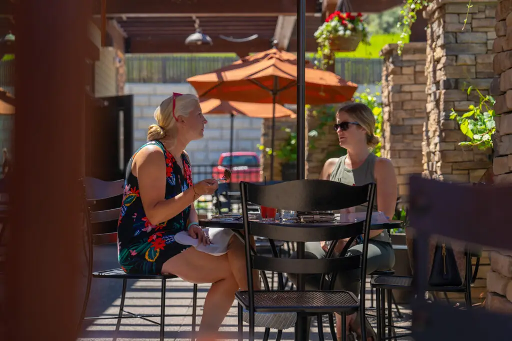 Two customers enjoying the sunny day at the outdoor seating section at the 8th Street at the Ivy