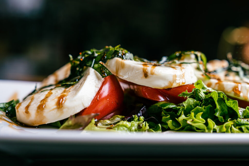 Fresh Salad topped with Mozzarella and tomato slices by the 8th Street at the Ivy