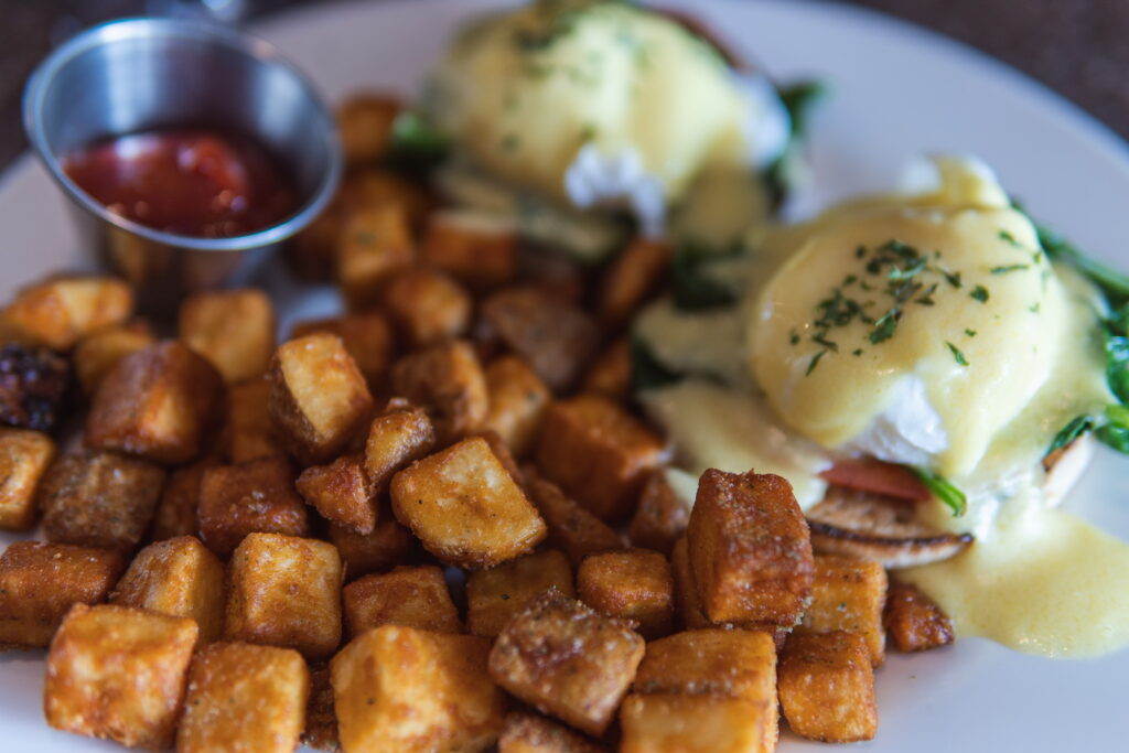 2 Poached eggs, sautéed spinach & tomato on a crisp English muffin topped with Hollandaise and potatoes.